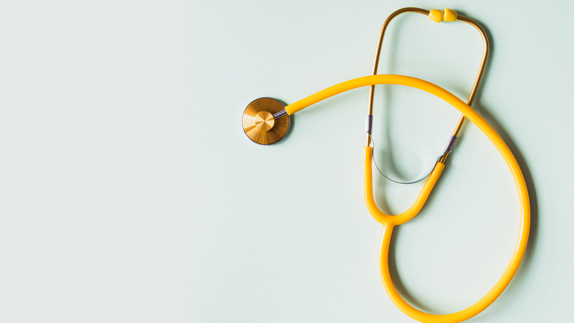Yellow stethoscope with a light teal background.